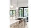 Farmhouse sink in a bright kitchen with backyard views, stainless steel appliances, and island seating at 1529 Tomato Farm Cir, Mount Pleasant, SC 29464