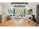 Bright living room with wood beam, large windows, and vaulted ceiling at 1529 Tomato Farm Cir, Mount Pleasant, SC 29464