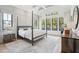 Bright main bedroom featuring vaulted ceilings, a canopy bed, and multiple windows at 1529 Tomato Farm Cir, Mount Pleasant, SC 29464