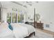This main bedroom features a four-poster bed, high ceilings, and a light-filled window area at 1529 Tomato Farm Cir, Mount Pleasant, SC 29464
