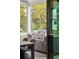 Outdoor kitchen on a screened porch with a grill and comfortable seating area at 1529 Tomato Farm Cir, Mount Pleasant, SC 29464