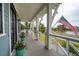 Relaxing front porch with ample seating, potted plants, and a view of the surrounding neighborhood at 1529 Tomato Farm Cir, Mount Pleasant, SC 29464