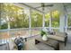 Relaxing screened porch features comfortable seating, coffee table, and views of the pool and backyard at 1529 Tomato Farm Cir, Mount Pleasant, SC 29464