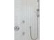 This glass enclosed shower is decorated with white chevron patterned marble and chrome fixtures at 1529 Tomato Farm Cir, Mount Pleasant, SC 29464