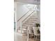 A modern staircase features wood steps, stainless steel rails, and a contemporary chandelier at 1529 Tomato Farm Cir, Mount Pleasant, SC 29464