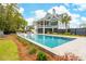 Backyard pool and home in the background with a slide and patio furniture at 1529 Tomato Farm Cir, Mount Pleasant, SC 29464