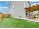 Spacious backyard with artificial grass, outdoor patio, and wood privacy fence provides an intimate entertaining area at 158 Garden Lily Ln, Summerville, SC 29485