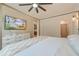 A sun filled bedroom with a ceiling fan, TV, and ample storage at 158 Garden Lily Ln, Summerville, SC 29485