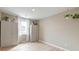 An empty bedroom with light hardwood floors, gray walls, two tall cabinets, and a window at 158 Garden Lily Ln, Summerville, SC 29485