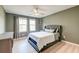 A charming bedroom filled with natural light, soft grey tones and light wood floors at 158 Garden Lily Ln, Summerville, SC 29485