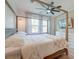 A bright, cozy primary bedroom featuring a four-poster bed and a wall-mounted television at 158 Garden Lily Ln, Summerville, SC 29485