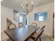 Elegant dining room with a modern chandelier, wood table, and views into other areas of the home at 158 Garden Lily Ln, Summerville, SC 29485
