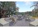 Outdoor firepit surrounded by Adirondack chairs, perfect for relaxation while enjoying the lake views at 158 Garden Lily Ln, Summerville, SC 29485