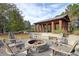 Outdoor firepit surrounded by Adirondack chairs, perfect for relaxation while enjoying the wooded views at 158 Garden Lily Ln, Summerville, SC 29485