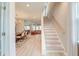 Bright and open foyer showcasing a staircase, wood floors, and seamless flow to the dining and living areas at 158 Garden Lily Ln, Summerville, SC 29485