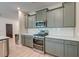 Charming kitchen with stainless steel appliances, white subway tile backsplash and gorgeous gray cabinets at 158 Garden Lily Ln, Summerville, SC 29485
