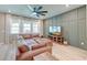 Spacious living room with a large sectional sofa, modern fan, and natural light, perfect for relaxation and entertainment at 158 Garden Lily Ln, Summerville, SC 29485