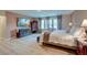 Well-lit main bedroom featuring wood floors, neutral paint, and a TV mounted above a dark dresser at 158 Garden Lily Ln, Summerville, SC 29485