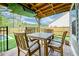 Covered back patio featuring an outdoor dining table with seating, brick pavers, and views of the yard at 158 Garden Lily Ln, Summerville, SC 29485