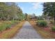 Scenic walking trail through a wooded area with a gazebo surrounded by lush greenery at 158 Garden Lily Ln, Summerville, SC 29485