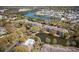 Community aerial view showcasing residences nestled amongst trees, ponds, and a community pool in a serene setting at 1597 Cambridge Lakes Dr # 303E, Mount Pleasant, SC 29464