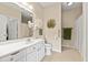 Well-lit bathroom featuring a white vanity, large mirror, and updated fixtures at 1597 Cambridge Lakes Dr # 303E, Mount Pleasant, SC 29464