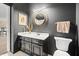 Modern bathroom with black vanity, gold accents, and decorative mirror at 1597 Cambridge Lakes Dr # 303E, Mount Pleasant, SC 29464