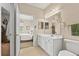 Bright bathroom featuring white vanity, mirror, and open doorway to bedroom at 1597 Cambridge Lakes Dr # 303E, Mount Pleasant, SC 29464
