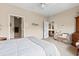 Bright bedroom featuring neutral decor, a ceiling fan, and an ensuite bathroom at 1597 Cambridge Lakes Dr # 303E, Mount Pleasant, SC 29464