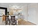 Modern kitchen featuring a breakfast bar, white cabinets, and seamless access to the living spaces at 1597 Cambridge Lakes Dr # 303E, Mount Pleasant, SC 29464