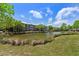 Scenic pond view showcasing the building's architecture with multi-level balconies and well-maintained landscaping at 1597 Cambridge Lakes Dr # 303E, Mount Pleasant, SC 29464