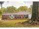 Lovely backyard featuring a brick house with a wooden deck, ideal for entertaining guests outdoors at 1756 Mchenry Ave, Charleston, SC 29412