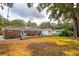 View of the home's backyard with the patio, lawn, shed, and brick on the rear of the home at 1756 Mchenry Ave, Charleston, SC 29412