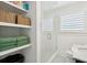 Bathroom with a glass enclosed shower, window with shutters, and open shelving at 1756 Mchenry Ave, Charleston, SC 29412
