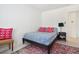 Bedroom with wainscotting, a patterned rug, and a reading lamp on the nightstand at 1756 Mchenry Ave, Charleston, SC 29412