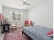 Cozy bedroom with wainscotting, a patterned rug, and a window letting in natural light at 1756 Mchenry Ave, Charleston, SC 29412