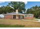 Charming brick home with a welcoming front porch, stone chimney and a well-maintained lawn at 1756 Mchenry Ave, Charleston, SC 29412