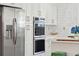 Contemporary kitchen showcasing stainless steel appliances, white cabinetry, and stylish hardware at 1756 Mchenry Ave, Charleston, SC 29412