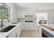 Bright kitchen featuring white cabinets, an island with seating, and modern finishes at 1756 Mchenry Ave, Charleston, SC 29412