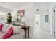 Bright living room features neutral sofa, colorful artwork and view into hall at 1756 Mchenry Ave, Charleston, SC 29412