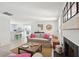 Bright and airy living room featuring a fireplace, sofa with pillows, and an open floor plan at 1756 Mchenry Ave, Charleston, SC 29412