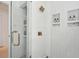 Glass shower with a brass handle, subway tile, and built-in shelving at 1756 Mchenry Ave, Charleston, SC 29412