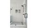 Modern tiled shower with a glass door and built-in shelving at 1756 Mchenry Ave, Charleston, SC 29412