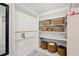 Spacious walk-in closet with white shelving, wooden hanging rod, and woven basket storage at 1756 Mchenry Ave, Charleston, SC 29412