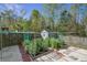 Backyard garden featuring raised beds, stone pavers, and a charming shed at 1909 Royal Empress Ct, Charleston, SC 29414