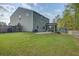 Home exterior from the spacious backyard featuring a screened in porch, shed, patio, and lawn at 1909 Royal Empress Ct, Charleston, SC 29414