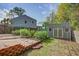 Fenced backyard with a garden, shed and a trellis covered in plants, offering a private outdoor space at 1909 Royal Empress Ct, Charleston, SC 29414