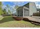 A backyard with a screened porch offers seamless indoor-outdoor living at 1909 Royal Empress Ct, Charleston, SC 29414