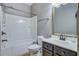Bathroom with a bathtub and shower, mirror, and dark vanity at 1909 Royal Empress Ct, Charleston, SC 29414