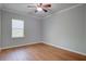 Cozy bedroom with a ceiling fan, window, and hardwood floors at 1909 Royal Empress Ct, Charleston, SC 29414